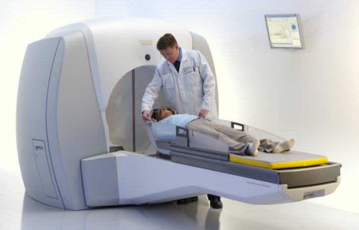Image of Gamma Knife device with patient and provider