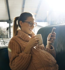 pregnant woman looking at her cell phone