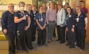Kelly and Radke pose with some of the providers on the BMT Unit at UCH who helped to care for her.