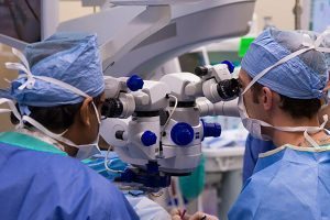 doctors seen from behind in a bionic eye surgery on a patient