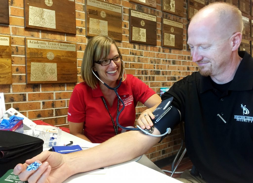 Melissa Armstrong, a health care screener with UCHealths Healthy Hearts, screens an employee of Rocky Mountain High School in 2016. Healthy Hearts recently got a grant to be able to extend the screenings to employees of Thompson School District. Photo courtesy of Healthy Hearts.