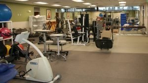 a gym with workout bikes and weights