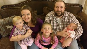 The carlson family sitting on a couch