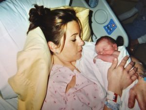 Jennifer holding her newborn son.