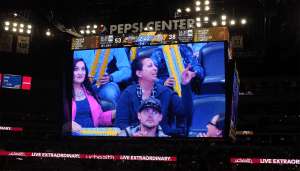 Val Sotelo, a UCHealth Memorial Hospital employee, is shown on the big screen at a Denver Nuggets basketball game.