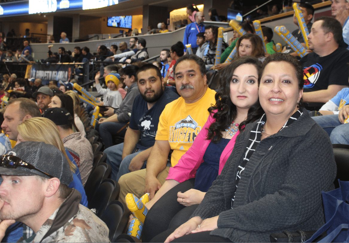 Val Sotelo (far right), is joined by her son, Nate; husband, Gus; and daughter, Shawna; during a recent Denver Nuggets game.