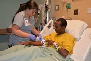 Bahta Wibshet receives care from a nurse at UCHealth Memorial Hospital.