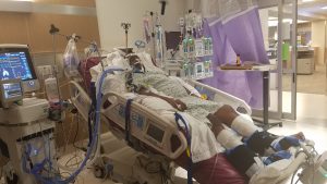 David Kenyatta lays in a hospital bed soon after his stroke.