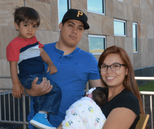 Elena. Alexandra holds the baby, while her father, Christian Cordero, and brother, Christian, 3, look on.