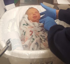 Newborn Alexa Crimando gets her first swaddle immersion bath with help from her parents and a Poudre Valley Hospital nurse.