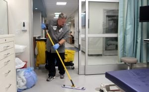Erich Bowen, an environmental services technician at the new UCHealth Longs Peak Hospital, mops a room in the ER.