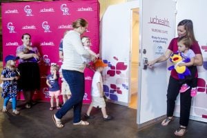 In this photo, mothers and children are shown outside a UCHealth Nursing Suite at Coors Field.