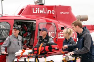 A UCHealth lifeline helicopter crew practices transferring a patient to an ambulance crew at UCHealth Longs Peak Hospital.