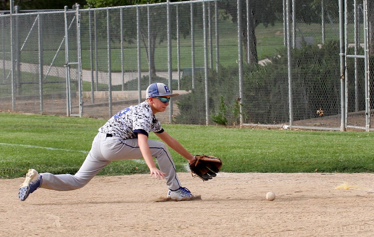 Brayden Tate playing baseball after a broken thumb.