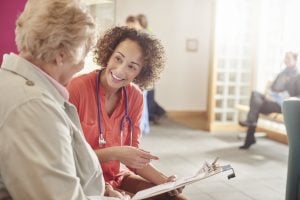 nurse talking to a lady in the waiting room.