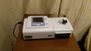 A CPAP machine sits beside the bed in one of the sleep rooms. Techs hook study patients to the machine if they reach a designated number of “incidents” that indicate obstructed breathing.