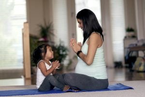 preparing my child for a new baby: pregnant mom plays with daughter