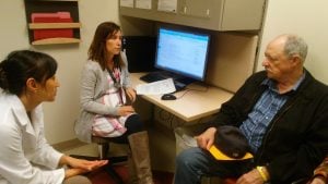 In this photo, Bill McDuffie visits with Enkhtsetseg Purev, MD, and nurse practitioner Chelsey Boggs.
