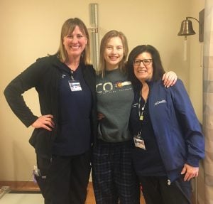 Peyton poses with two of her health care workers at University of Colorado hospital.