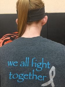 Makayla Brossman wears a T-shirt that shows how the Cheyenne Wells community is supporting her mother.