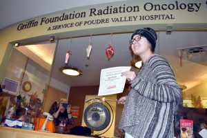 Kate Prewett shows a certificate she received after completing radiation treatment.