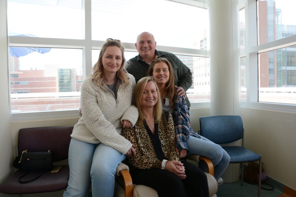 Cancer patient Evelyn Schwandt withher two grown daughters and her husband at UCHealth University of Colorado Hospital. The family supports Schwandt as she copes with two unrelated cancers.