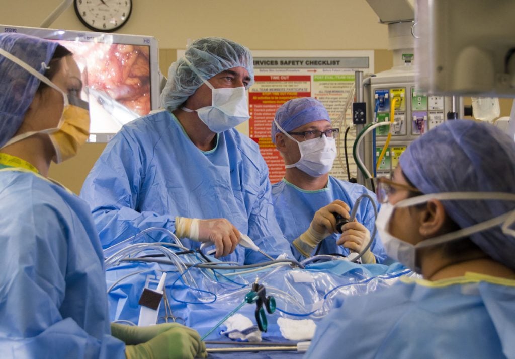 A team of surgeons performs surgery in an operating room at UCHealth University of Colorado Hospital.