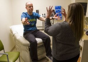 A neurologist leads patient Mike Moyles through a series of tests.