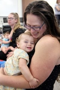 Amy Quinn cuddles her daughter, Elsa, while another mother breastfeeds her baby.