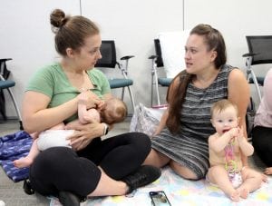 nursing mom talks to another mom at breastfeeding support group.