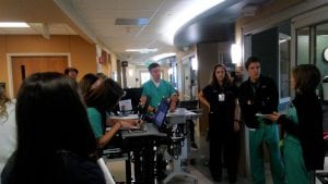 Dr. Jason Brainard, (center), medical director of the Surgical Trauma ICU at UCHealth University of Colorado Hospital, leads morning patient rounds.