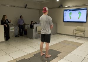 Standing on force plates in the clinical motion and performance laboratory, Hammond observes real time how his weight is distributed.