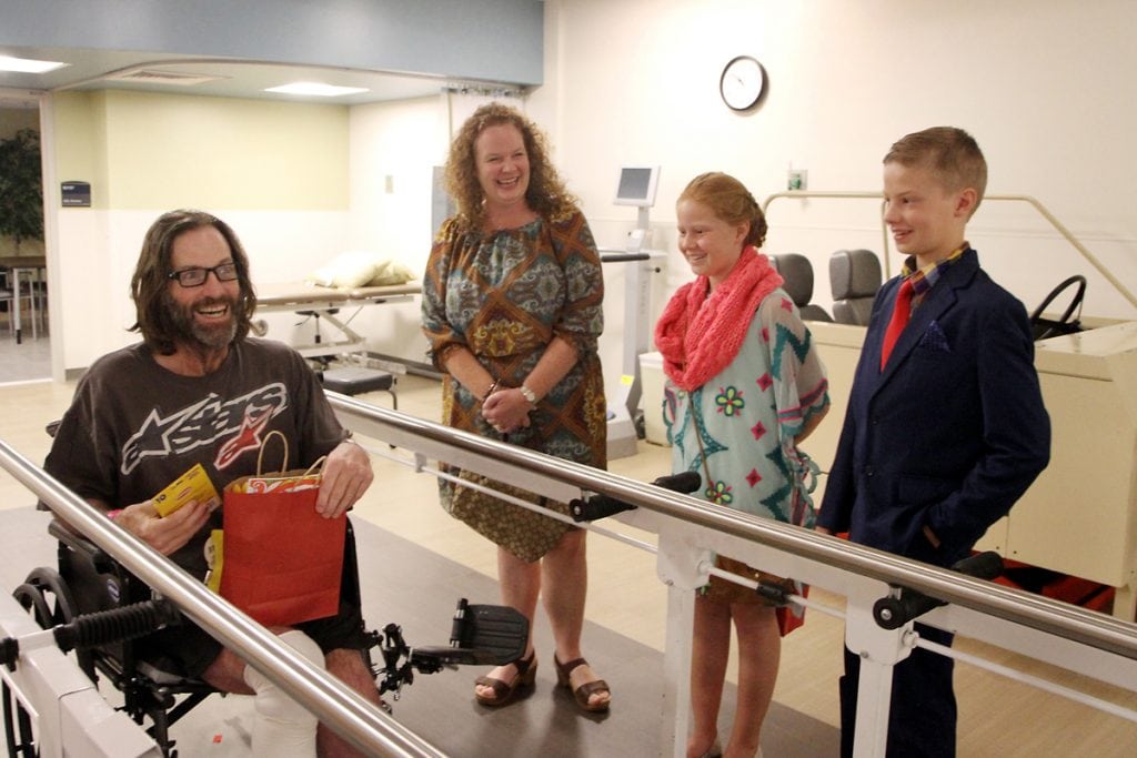 A patient laughs with charlie and his family.