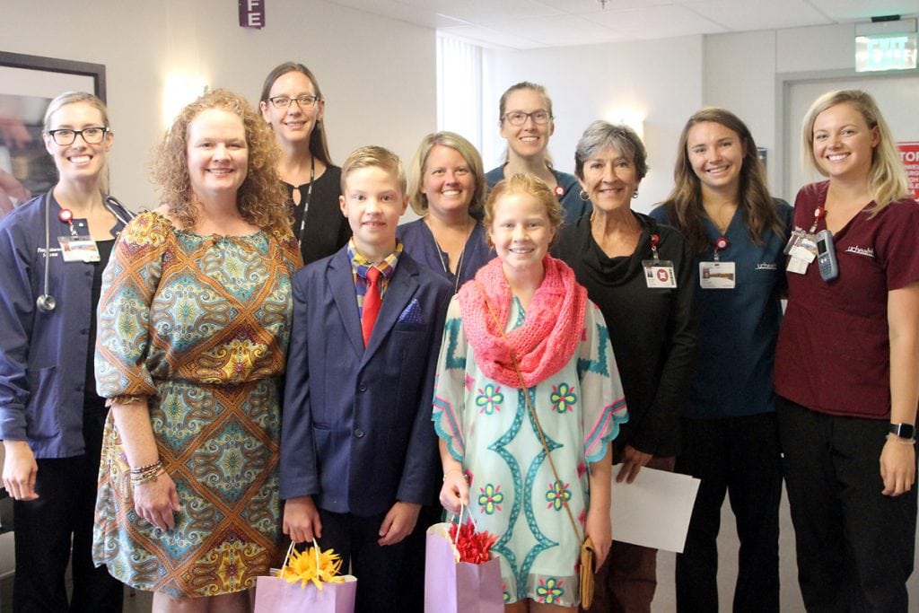 Charlie and his family take a picture with the PVH Rehab staff.
