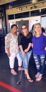 Erika Leiker, center, with friends at a Top Golf team-building event. Leiker hopes the Elira unit can help her reach her weight-loss goal of 30 pounds.