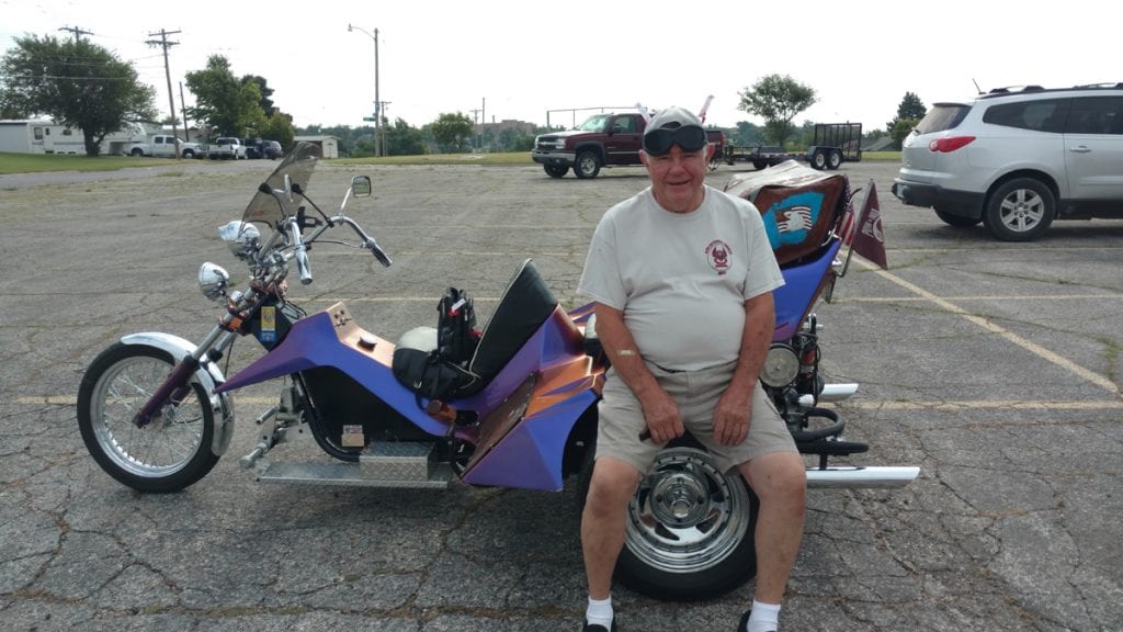 A photo of Larry Batman with his three-wheel bike.