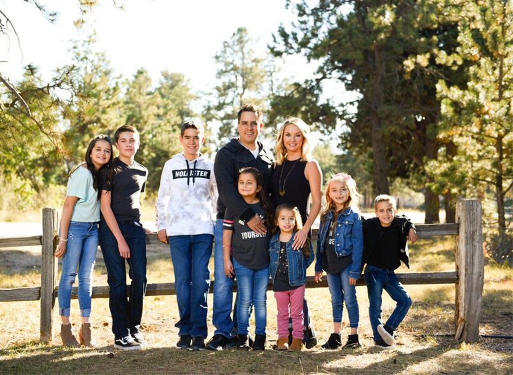 The Cuellar family poses for a photo at Black Forest Regional Park: (From L to R) Samantha, 17; Aiden, 13; Michael, 14; Randy; Grace, 9; Shelly; Victoria, 3 ½; Isabella, 7; and Jeremiah, 5.
