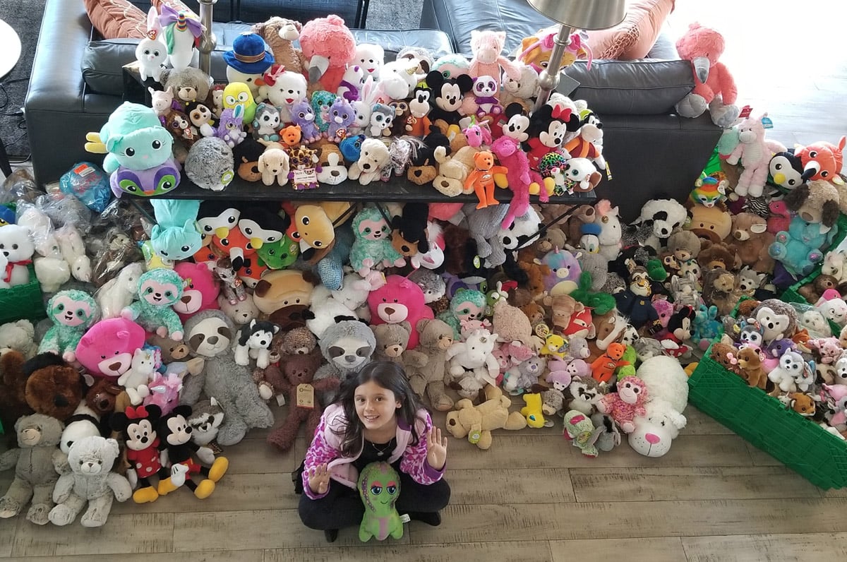 Marlie Walker with all the stuffed animals she collected.
