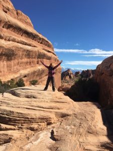 In this photo, Phyllis stands in the middle of Arches National Park.