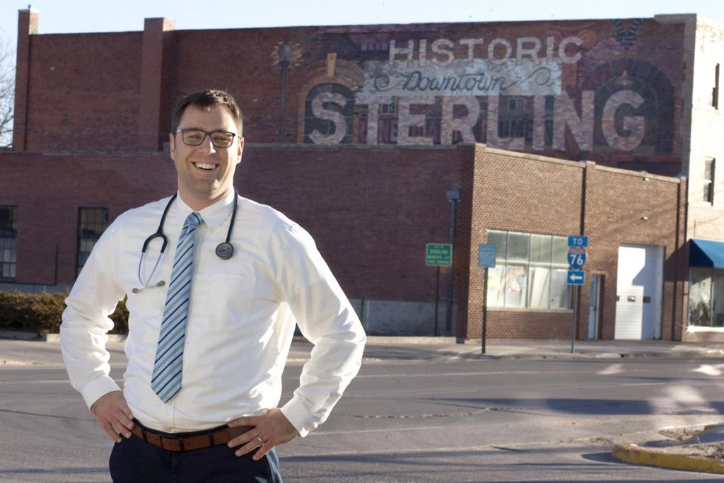Dr. Daniel Lambrecht, a primary care doctor for UCHealth in Sterling, Colorado, poses on the corner of North Fourth Street in Sterling’s historic downtown on Jan. 15., 2019. 