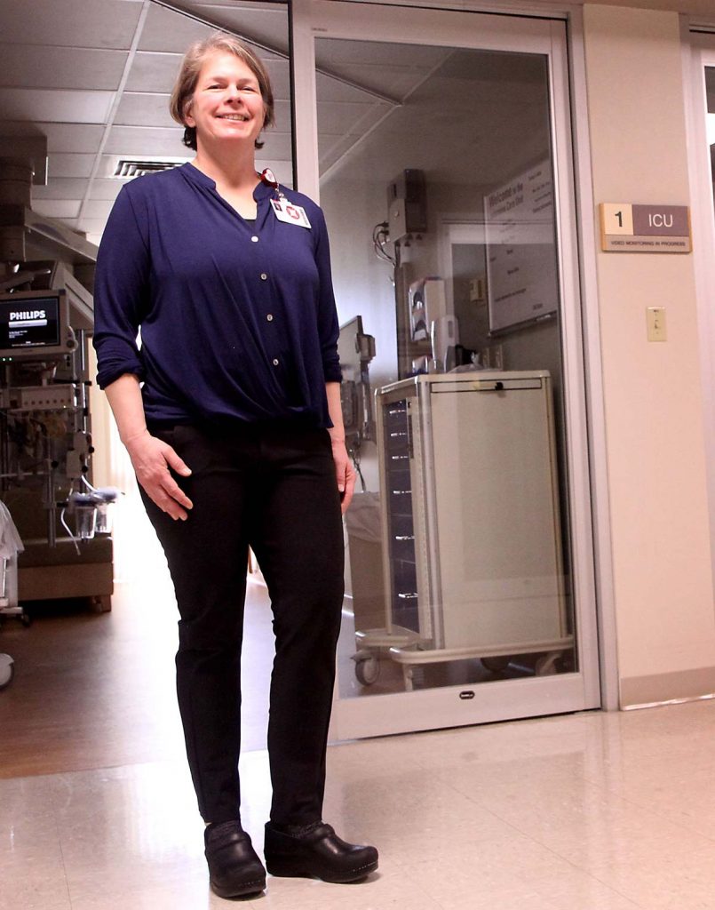 nurse stands in ICU unit