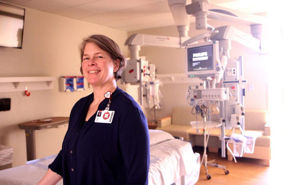 nurse stands in ICU room