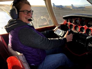 pilot sits in cockpit of small plane