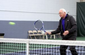 Jim playing tennis.