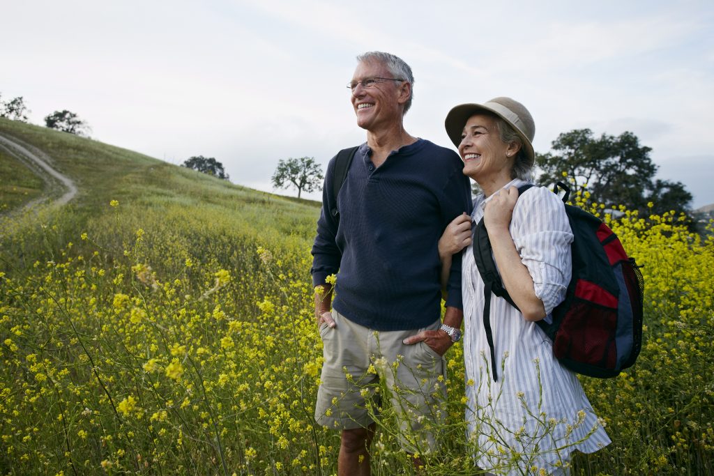 A couple stands in a field in this photo.