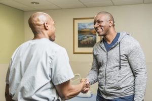 A doctor shakes hands with a patient. 10% of patients report a penicillin allergy but 90% can actually tolerate the treatment.
