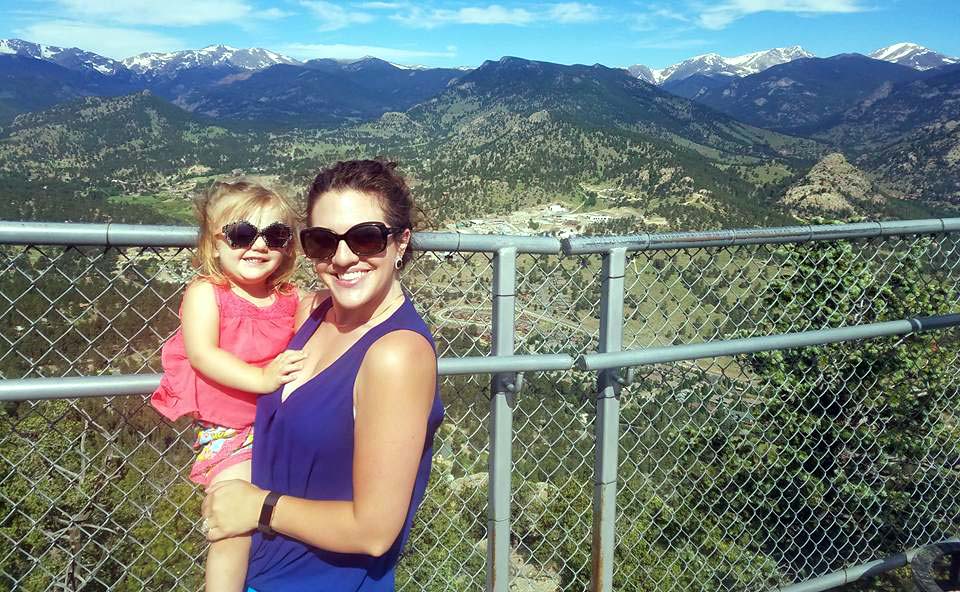 mom holding toddler at an overlook