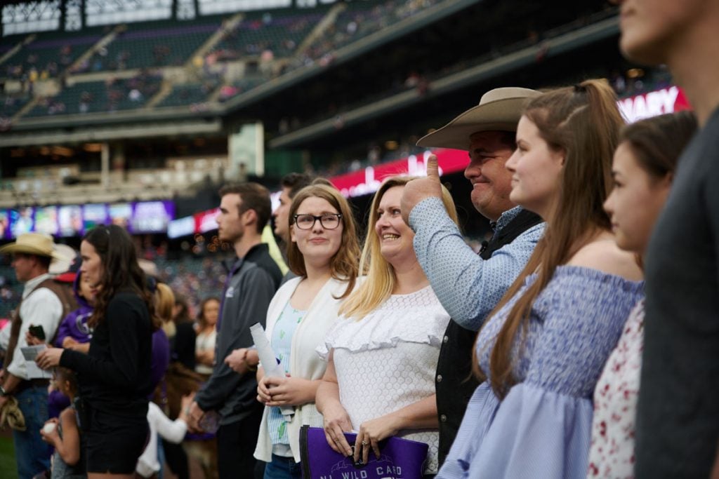Mike and his family line up for the playing of the national anthem at Coors Field.