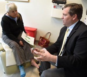 Dr. Kenneth Hunt holds a metallic copy of Deanne Carlson’s talus bone, one of three slightly different-sized versions created for her prior to her November 2018 ankle-repair surgery.