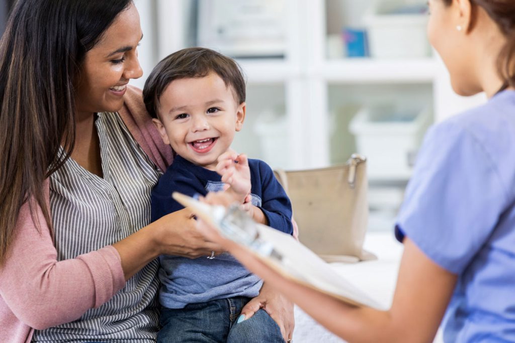 A photo of a mom with child at a doctor's office.
